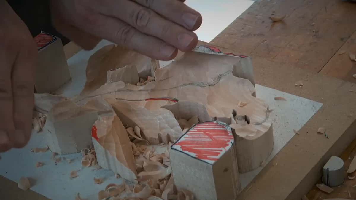 Fingers over the carving and a red line