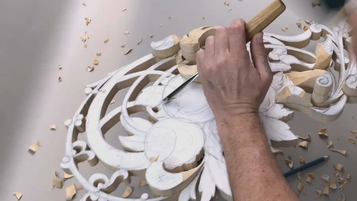 Gouge working the glued layers under the pattern