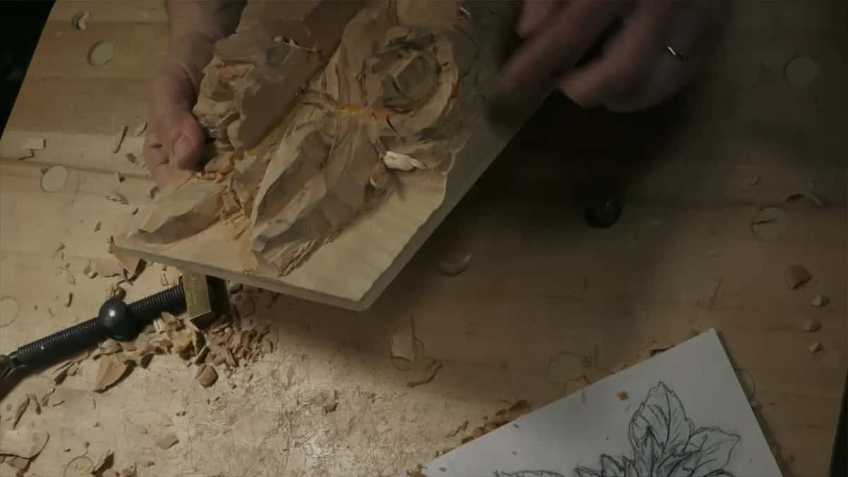 The panel lifted on its edge so its depth faces the camera, with the paper drawing lying on the bench