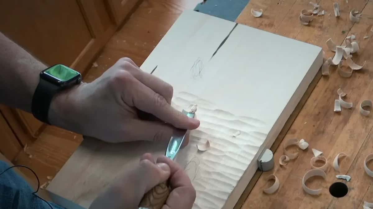 Two hands on one gouge over rippled ground