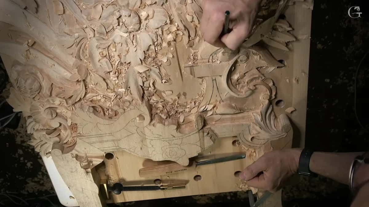 The whole ornament from above, with tools laid out on the bench below it