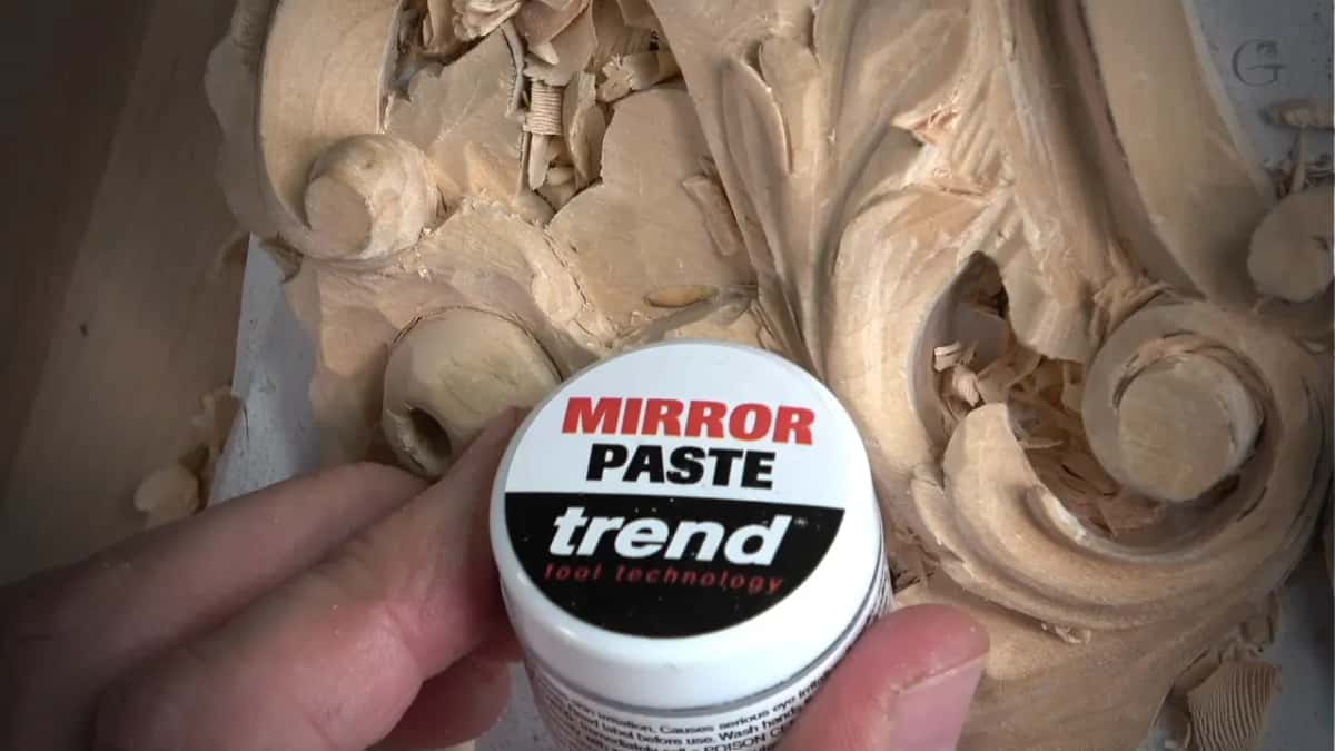 Tub of Trend Mirror Paste held up over the carving