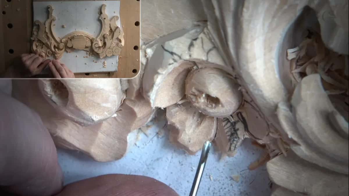 Small tool below the round center, with pencil lines on the petals and an inset of his hands at the panel