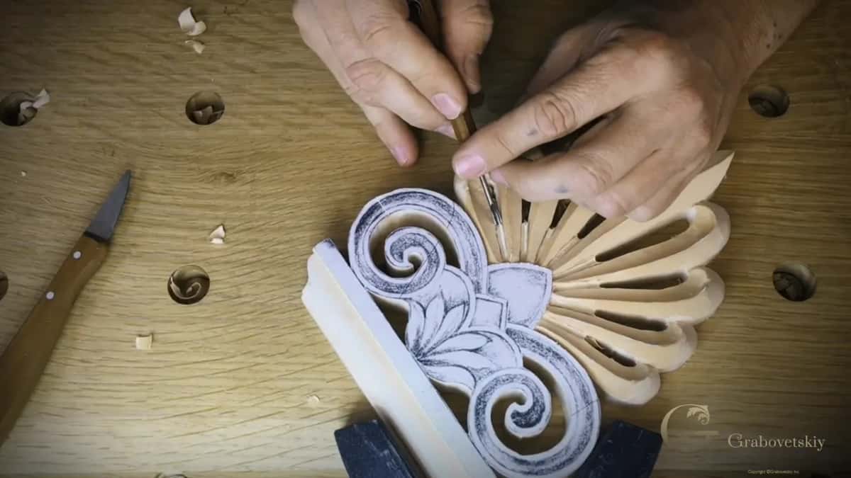 Fingers guiding a tiny tool near the center