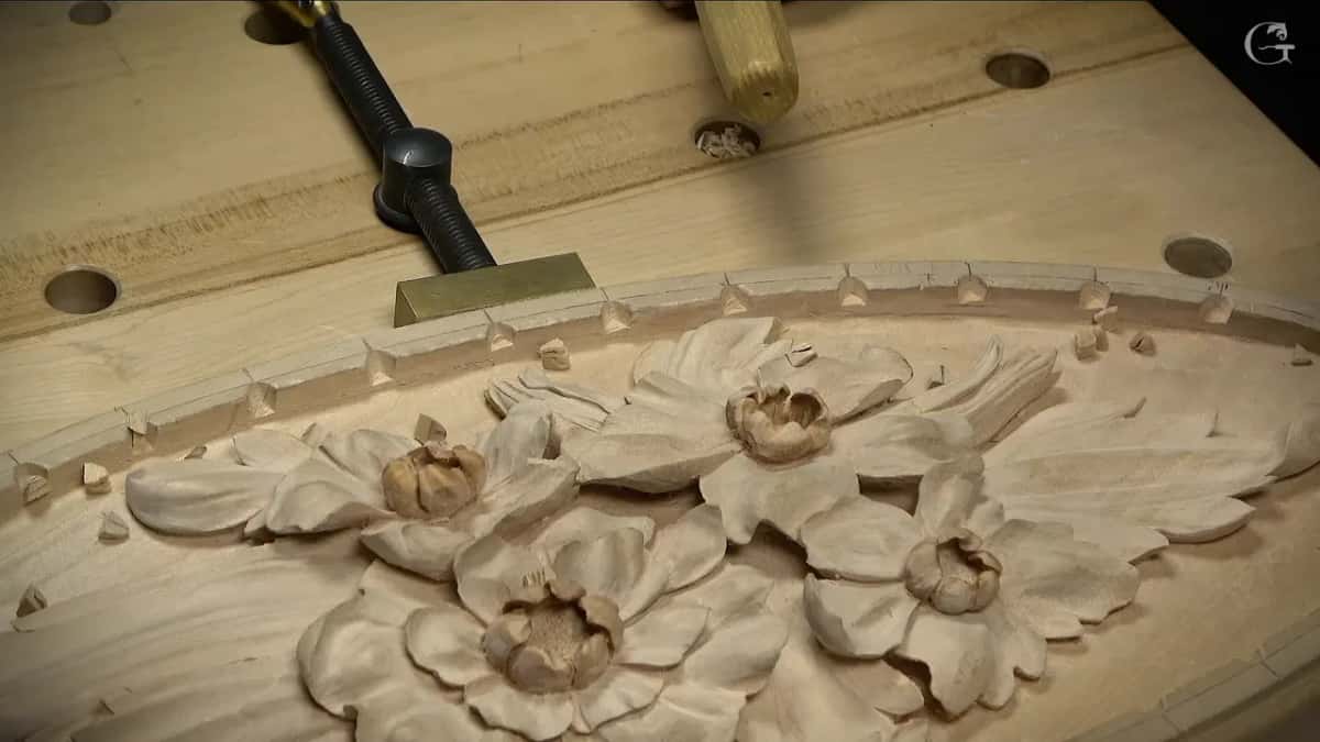 Small chopped notches run along the top of the molding, and loose chips lie below them