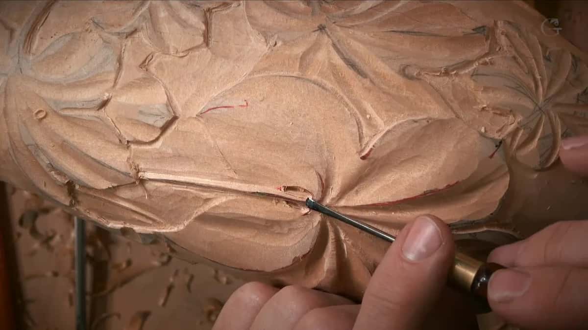 Brass ferrule tool working where the stem meets the leaf center, with red marker still showing
